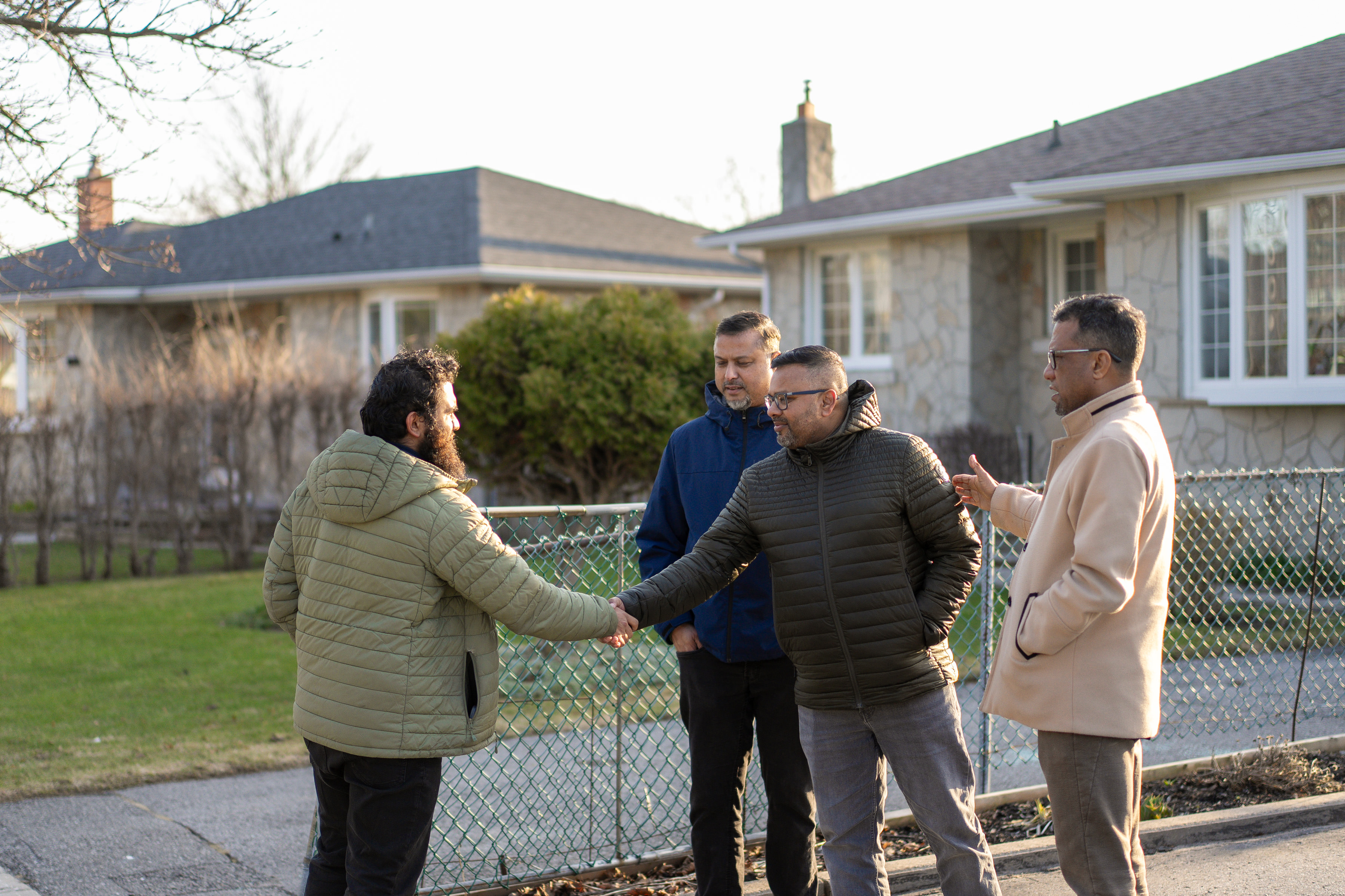 Hafiz shaking hands with a supporter